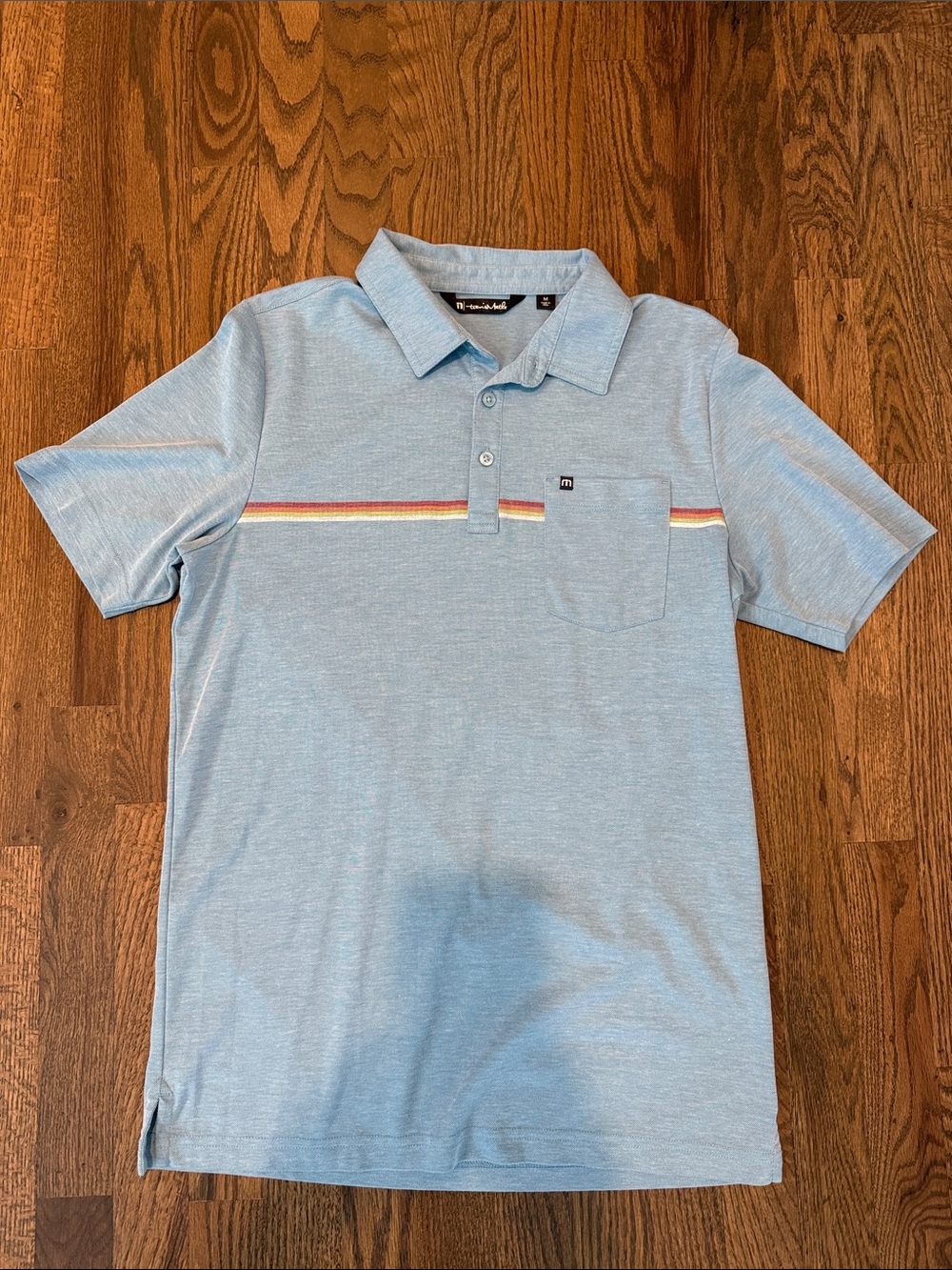 Travis Mathew Light Blue Polo with Retro Chest Stripe